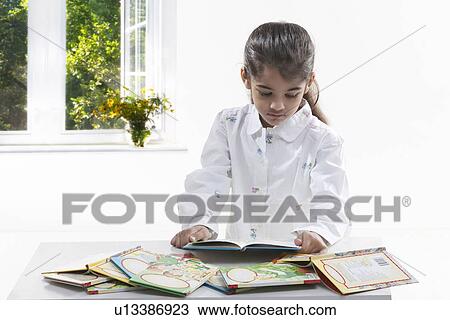 Girl reading a book View Large Photo Image Stock Image - Girl reading a book. Fotosearch