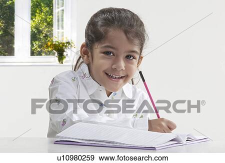Stock Photo - Girl with a book and pencil. Fotosearch
