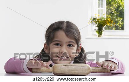 Girl with a rolling pin View Large Photo Image Stock Photo - Girl with a rolling pin. Fotosearch