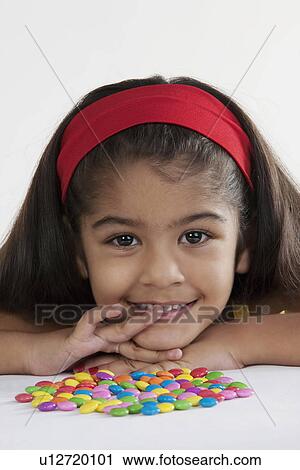 Girl with different coloured sweets View Large Photo Image Stock Image - Girl with different coloured sweets. Fotosearch