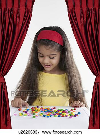 Girl with different coloured sweets View Large Photo Image Stock Photo - Girl with different coloured sweets. Fotosearch