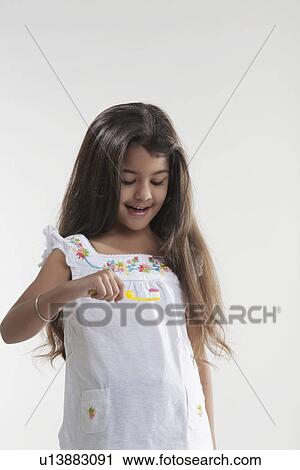 Stock Image - Girl with toothbrush and toothpaste. Fotosearch