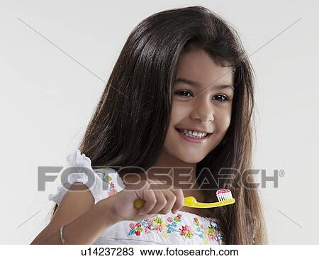 Stock Image - Girl with toothbrush and toothpaste. Fotosearch