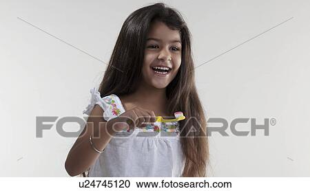 Stock Image - Girl with toothbrush and toothpaste. Fotosearch