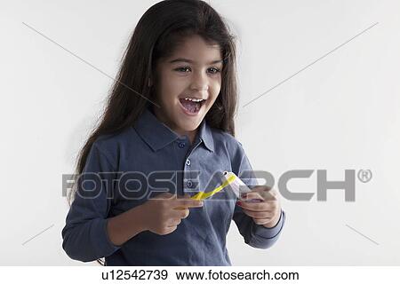 Stock Photo - Girl with toothbrush and toothpaste. Fotosearch