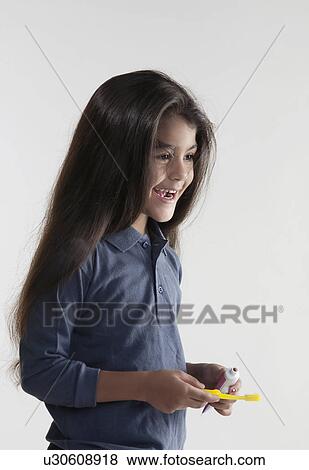 Girl with toothbrush and toothpaste View Large Photo Image Stock Photo - Girl with toothbrush and toothpaste. Fotosearch