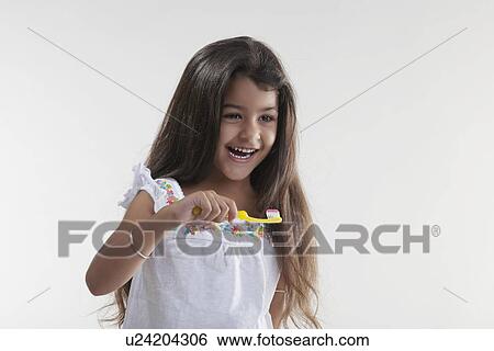 Stock Photograph - Girl with toothbrush and toothpaste. Fotosearch