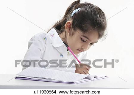 Girl writing in a notebook View Large Photo Image Picture - Girl writing in a notebook. Fotosearch