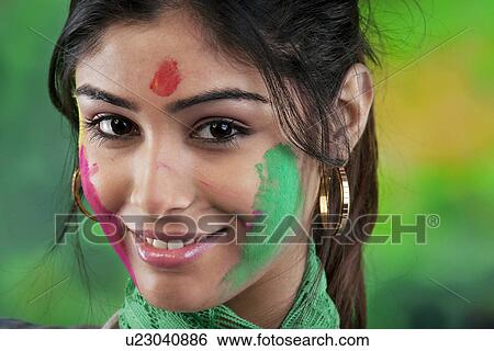 Holi colours on woman's face View Large Photo Image Stock Photograph - Holi colours on woman's face. Fotosearch