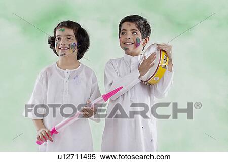 Stock Photography - Kids enjoying themselves on holi. Fotosearch