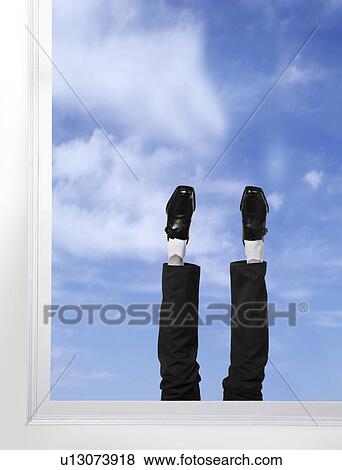 Stock Photo - Legs of a businessman outside a window. Fotosearch