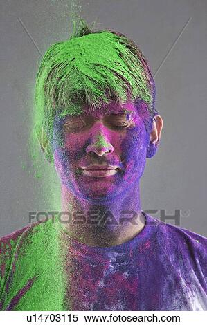 Stock Photography - Man covered in holi colours. Fotosearch