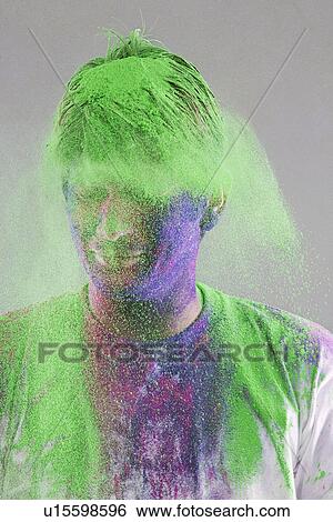 Stock Photograph - Man covered with holi colours. Fotosearch