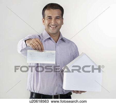 Stock Image - Man holding a house model and cheque. Fotosearch
