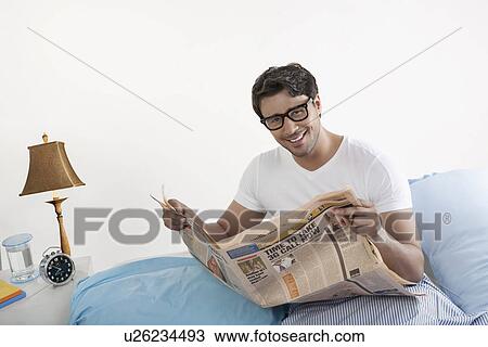 Man holding a newspaper View Large Photo Image Stock Image - Man holding a newspaper. Fotosearch