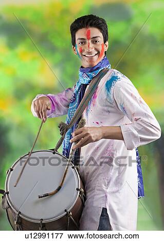Man playing on a dhol View Large Photo Image Stock Photo - Man playing on a dhol. Fotosearch