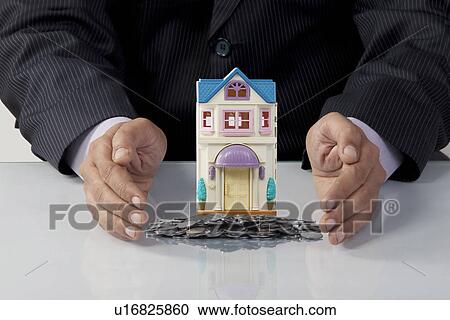 Stock Image - Man protecting his savings. Fotosearch
