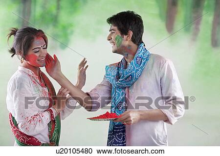 Man putting colour on a woman's face View Large Photo Image Stock Image - Man putting colour on a woman's face. Fotosearch