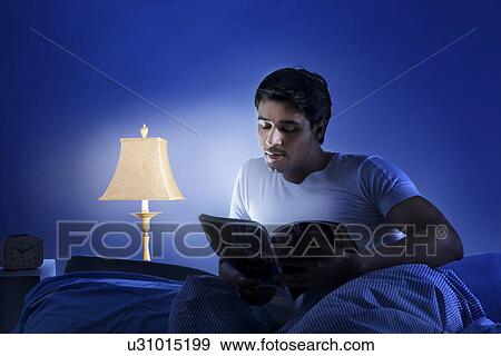 Stock Photo - Man reading a magazine. Fotosearch