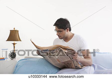 Picture - Man reading a newspaper. Fotosearch