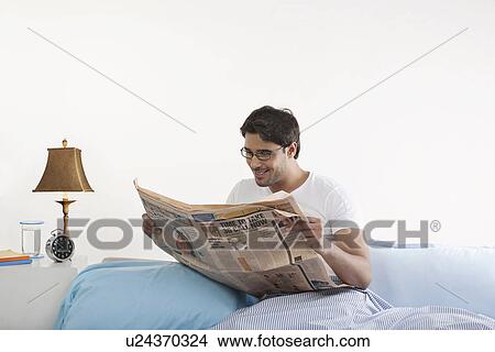 Man reading a newspaper View Large Photo Image Picture - Man reading a newspaper. Fotosearch