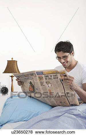Stock Photo - Man reading a newspaper. Fotosearch