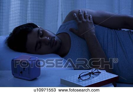 Stock Image - Man sleeping in bed. Fotosearch