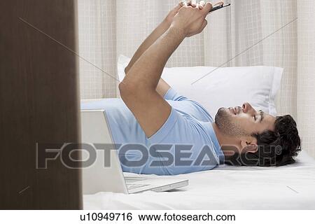 Stock Photograph - Man with a mobile phone. Fotosearch