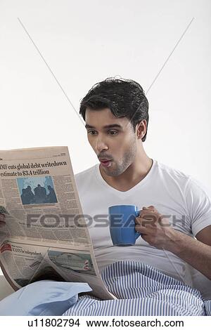 Picture - Man with a newspaper and coffee. Fotosearch