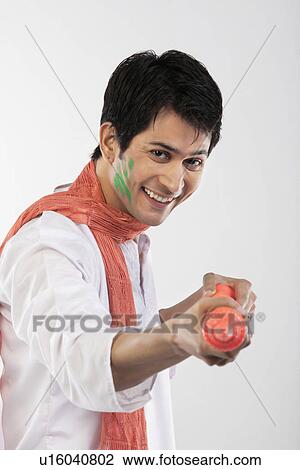 Stock Image - Man with a pichkari. Fotosearch