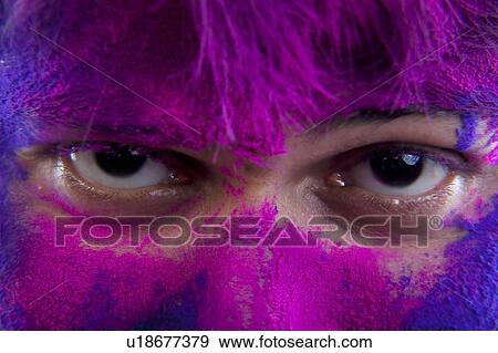 Stock Photo - Man's face covered in holi colours. Fotosearch