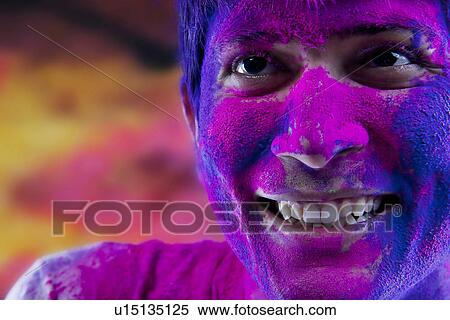 Man's face covered in holi colours View Large Photo Image Stock Photography - Man's face covered in holi colours. Fotosearch