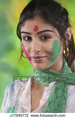 Stock Image - Portrait of a woman with colour on her face. Fotosearch