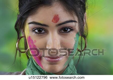 Stock Photograph - Portrait of a woman with colour on her face. Fotosearch