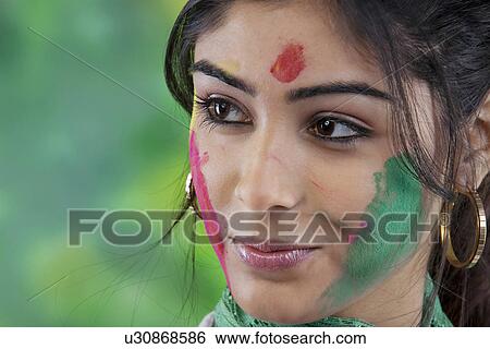 Portrait of a woman with colour on her face View Large Photo Image Stock Photograph - Portrait of a woman with colour on her face. Fotosearch