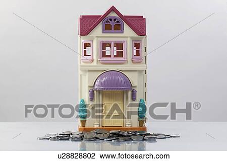 Toy house and coins View Large Photo Image Stock Image - Toy house and coins. Fotosearch