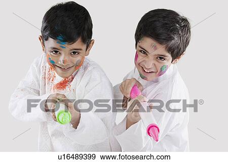Stock Photo - Two boys playing with pichkaris. Fotosearch