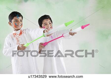 Stock Photo - Two boys playing with pichkaris. Fotosearch
