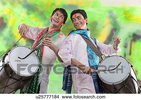 Picture - Two men playing on dholaks. Fotosearch