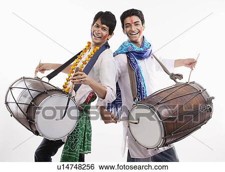 Two men playing on dholaks View Large Photo Image Stock Photograph - Two men playing on dholaks. Fotosearch