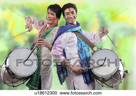 Stock Image - Two men playing on dhols. Fotosearch