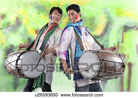 Stock Image - Two men playing on dhols. Fotosearch