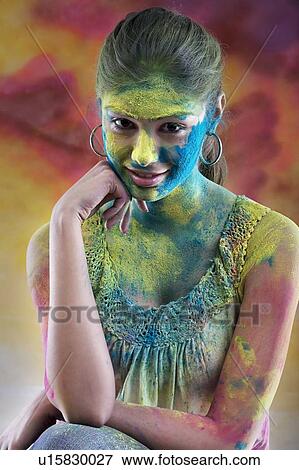 Stock Photo - Woman covered in holi colours. Fotosearch