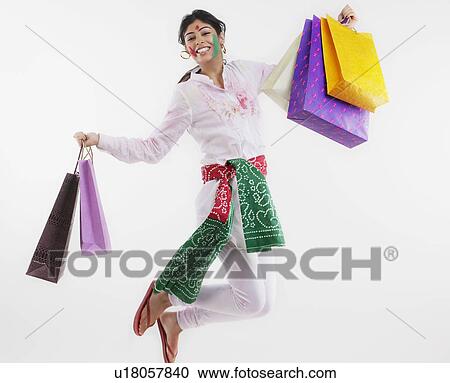 Woman jumping with shopping bags View Large Photo Image Stock Image - Woman jumping with shopping bags. Fotosearch