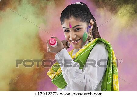 Stock Image - Woman with a pichkari. Fotosearch