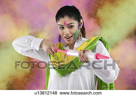 Stock Photo - Woman with a pichkari. Fotosearch
