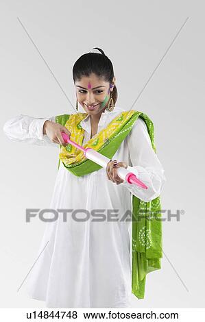Stock Photo - Woman with a pichkari. Fotosearch