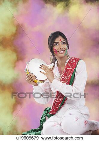 Stock Photo - Woman with a tambourine. Fotosearch