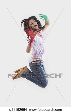 Woman with coloured palms jumping View Large Photo Image Picture - Woman with coloured palms jumping. Fotosearch