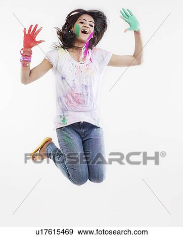 Stock Photo - Woman with coloured palms jumping. Fotosearch